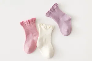 Detailed shot of 3-pair cotton baby princess mid-calf socks with cute ruffled lace cuffs.