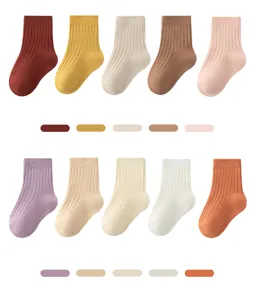 Detailed view of colorful baby ribbed cotton socks featuring solid hues and soft elastic cuffs.