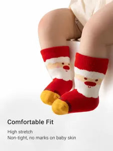 Cute Christmas plush towel socks for kids, thick cotton mid-tube socks with Santa design.