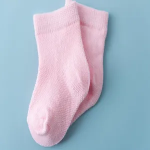 Close-up detail of soft pink cotton baby socks featuring a comfortable ribbed cuff design.