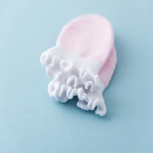 Newborn baby anti-scratch cotton mittens detail showing cute ruffles and pink stripes.