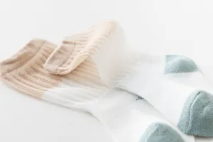Close-up detail view of breathable infant mesh socks featuring a cute color-blocked design.