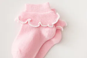 Pink cotton princess mid-tube socks with cute ruffles for baby girls, soft and breathable fabric.
