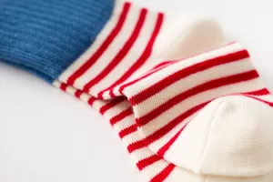 Detailed view of kids striped cotton socks featuring a cozy red, white, and blue design.