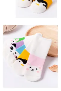Thick cozy kids winter socks with cute cartoon animal patterns close up detail view.