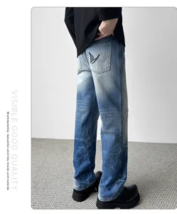 Detailed back view of men's vintage distressed loose denim jeans with unique pocket embroidery.