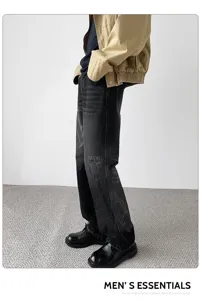 Men's American high street retro distressed patch black jeans detail showcasing loose fit.