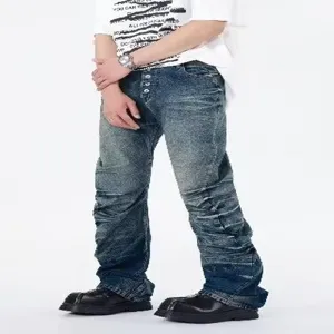 Men's blue washed distressed stacked flare jeans with multiple buttons, European street style.