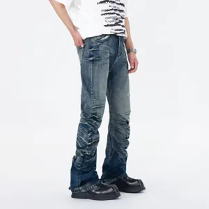 Detail shot of men's blue stacked flared denim jeans with unique wave pleats and street style.