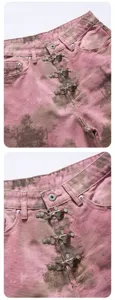 Close-up detail view of pink tie-dye denim shorts featuring metal clasp front closure.