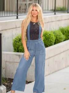 Detail view of women's lightweight denim overalls featuring wide legs and comfortable casual fit.