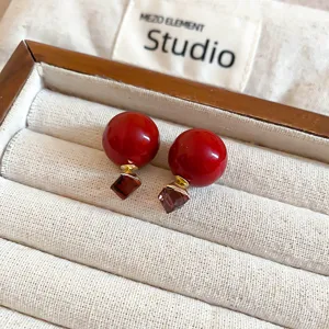 Rote Kugel quadratischer Edelstein Ohrring Nahaufnahme mit schickem Design und trendigem Look.