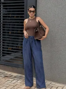 Casual street style denim wide-leg pants detail shot, showcasing high waist and drawstring.