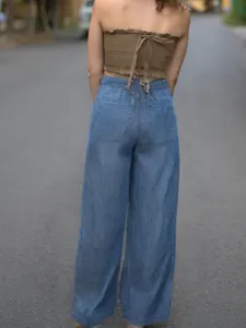 Detailed back view of casual women's tencel wide leg denim jeans with stylish strapless top.