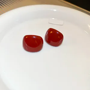 Retro deep red square earrings detail view, elegant niche fashion jewelry piece.
