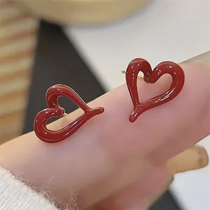 Red asymmetric heart earrings, retro style glossy enamel metal ear studs for women.