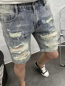 Men's light blue distressed denim shorts with paint splatter, high street casual pants.