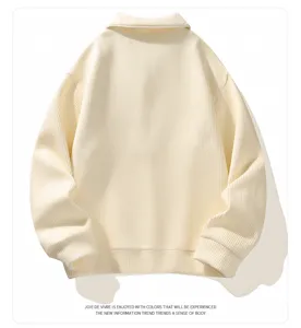 Close-up of the cream knit collar and ribbed texture on this casual polo sweater.