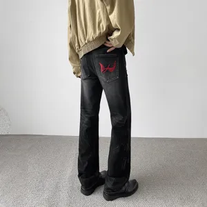 Mens vintage washed distressed straight leg denim jeans with red embroidery patch back view