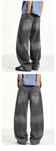 Men's loose washed baggy denim jeans with artistic paint splatter details, back view detail.