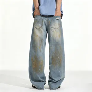 Men's loose fit blue washed distressed denim jeans featuring unique paint splatter details.