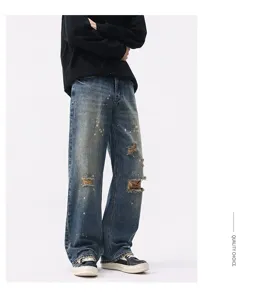 Men vintage washed baggy blue jeans with distressed paint splatter design for casual wear.