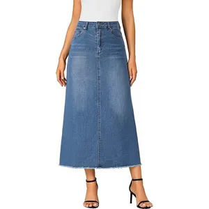 Close-up view of the raw-edge denim skirt detailing, high waist, and structured A-line seam.
