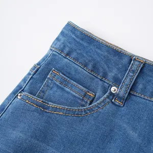 Blue denim skirt waist and pocket detail close-up view showing neat contrast stitching.
