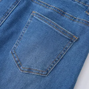 Detailed view of women's blue denim skirt back pocket with contrast yellow stitching texture.