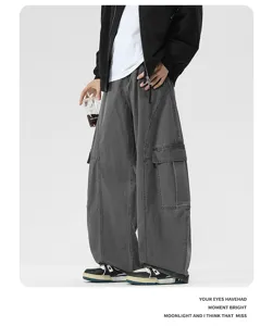 Close-up view of dark grey baggy wide-leg scimitar casual jeans showing stereo tailoring.