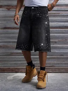 Detail en gros plan de short en denim noir pour homme avec ornements en strass et franges.