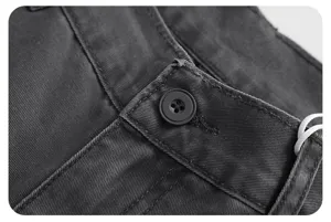 Close-up detail of dark gray retro casual pants waistband with button and fine stitching.