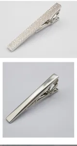 Close-up detail of silver metal tie clip with textured and smooth surface for men suit wear.