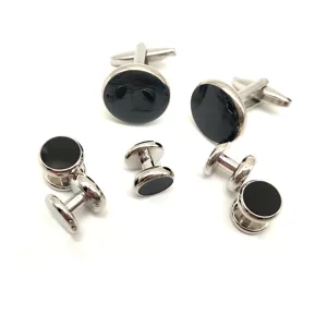 Detailed view of elegant silver-tone metal cufflinks with black inlay for men's formal shirts.