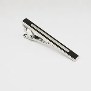 Men's business metal tie clip closeup, silver and black geometric pattern design detail.