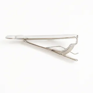 Vintage whale tie clip detail shot, elegant copper fashion accessory in silver tone.