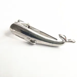 Detailed closeup of the silver whale tie clip, displaying the fine metal texture and clasp.