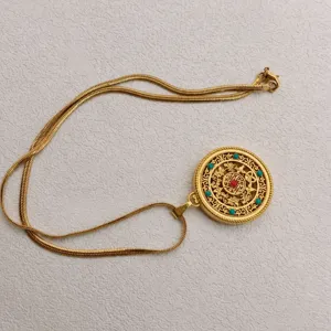 Retro Chinese style gold plated filigree hollow pendant necklace with lucky symbols detailed view.
