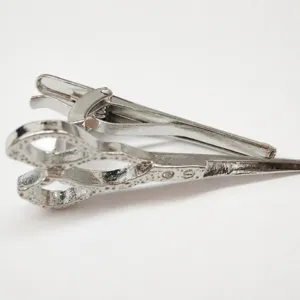 Silver metal tie clip featuring a stylish scissors design, ideal men's fashion accessory.