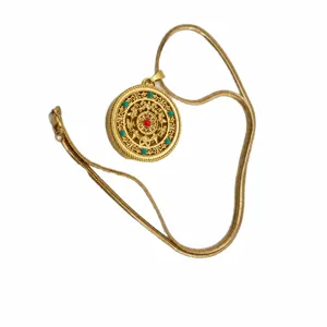 Vintage sand gold-plated openwork round pendant necklace with red and turquoise stone accents.