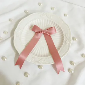 Fiocco in nastro di raso rosa per confezioni regalo, decorazioni e accessori artigianali.