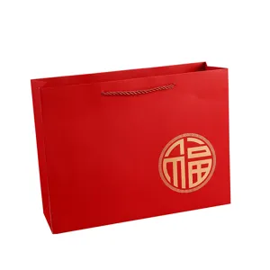 Red paper gift bag with gold Fu character for wedding packaging and festive gift giving