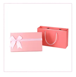 Pink gift box set with satin bow and matching paper bag for present packaging details.