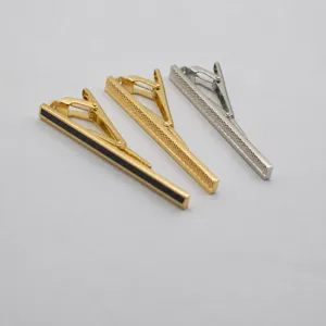 Elegant copper tie clips in gold and silver finish, luxury business office accessories.