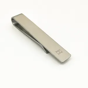 Stainless steel tie clip detail showing brushed texture and engraved letter H design.