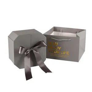 Gray octagonal gift box with ribbon and matching tote bag for cosmetics and party favors.