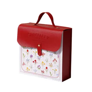 Red leather gift box with handle and floral front panel, ideal for birthday party favors.