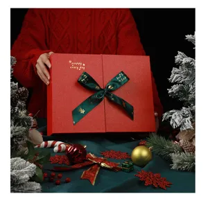 Christmas red gift box for holiday packaging, elegant empty present box with green ribbon.