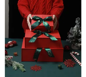 Christmas red gift box set with green ribbon, festive packaging for apples and holiday presents.
