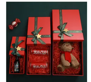 Christmas red gift box set with ribbon and festive filler for holiday presents.